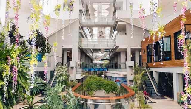 Modern Atrium at Village Market, airy venue with greenery for events and conferences.