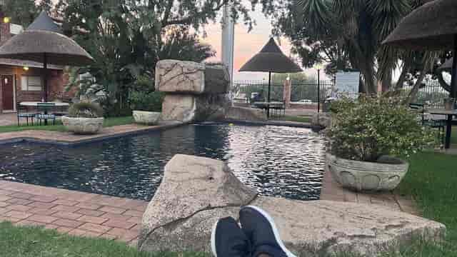 Serene Masai Mara venue with pool and greenery, perfect for meetings and events.