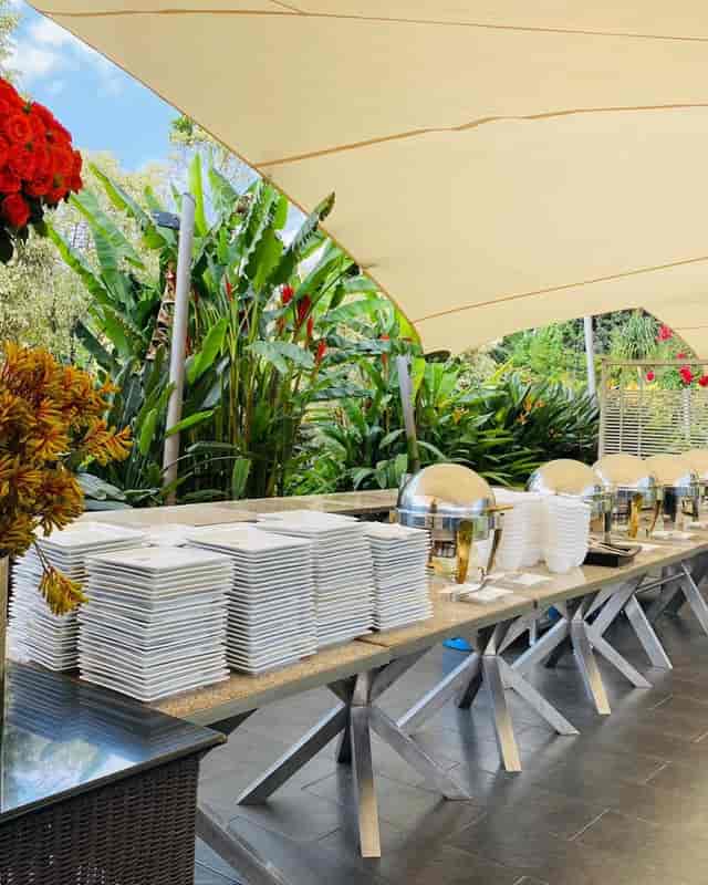 Indoor Zen Garden buffet setup with elegant dishes, perfect for outdoor events.