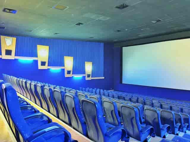 Modern movie theater auditorium with tiered seating for events and screenings.