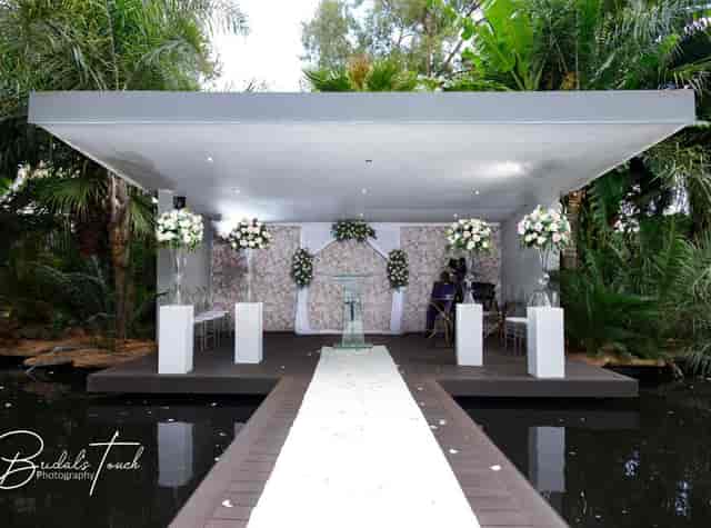 Outdoor wedding venue with floral decor and serene garden setting at The Forum.