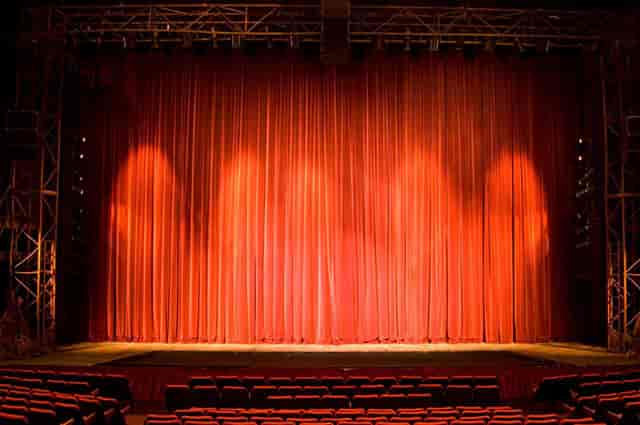Spacious Joburg Theatre stage with red curtains, perfect for performances and presentations.