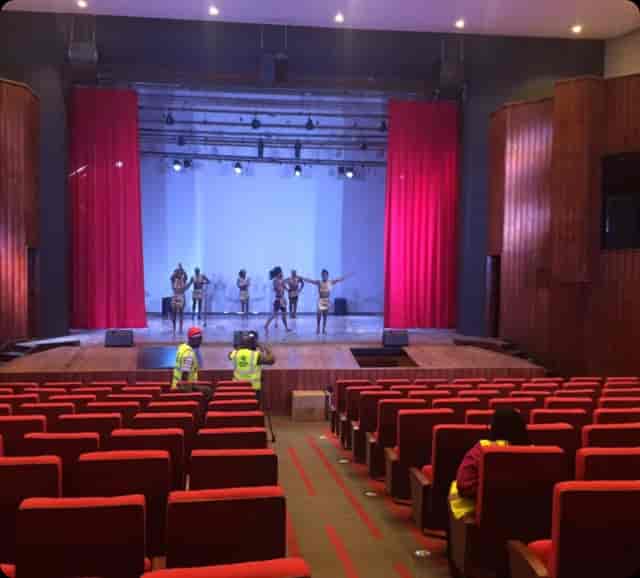 Cultural center auditorium stage setup for performance rehearsal with audience seating.