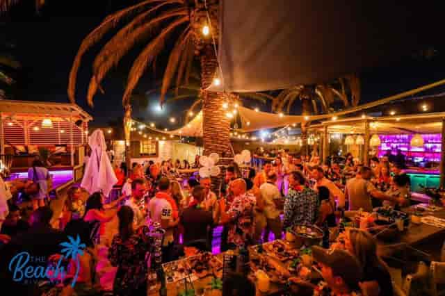 Vibrant outdoor bar venue with string lights, perfect for networking events and celebrations.