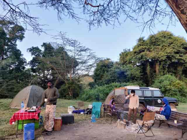 Public Campsites at Lake Nakuru: Tents and cozy fire for team-building retreat.