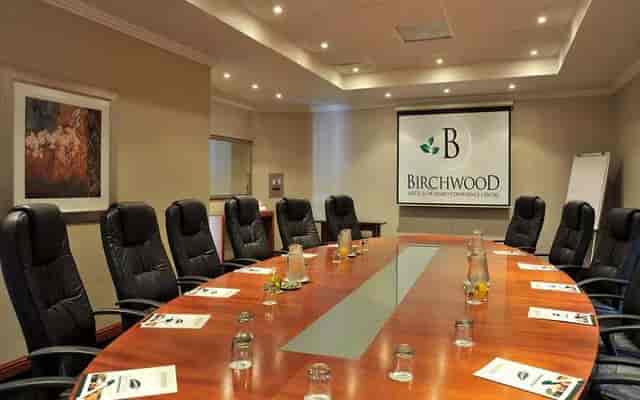 Boardroom at Birchwood Hotel with polished table, ideal for corporate meetings and events.