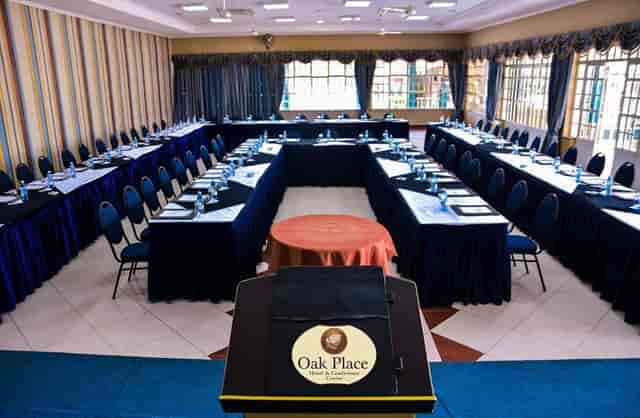 Conference room with U-shaped seating in Oak Place Hotel, ideal for corporate events and workshops.