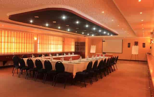 Conference room with U-shaped seating at Oak Place Hotel for corporate events and workshops.