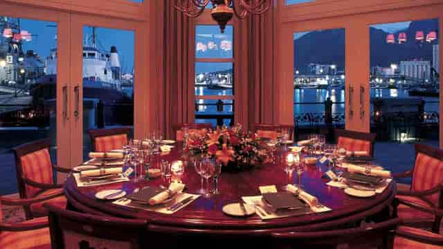 Elegant circular dining setup with floral centerpiece for sophisticated events at The Table Bay.