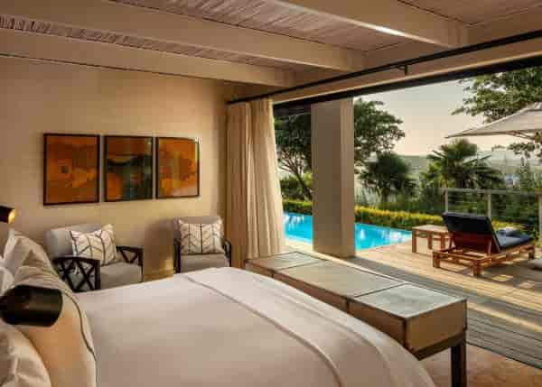 Luxurious hotel suite at Presidential Lodge 2 with serene pool view, perfect for retreats.