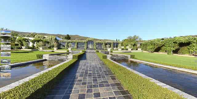 "Belair Gardens venue with landscaped pathway, perfect for outdoor events and meetings."