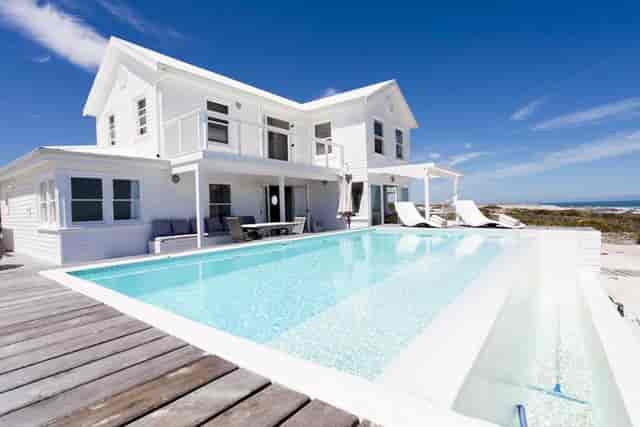 Modern beachfront villa with infinity pool for luxury events and retreats.