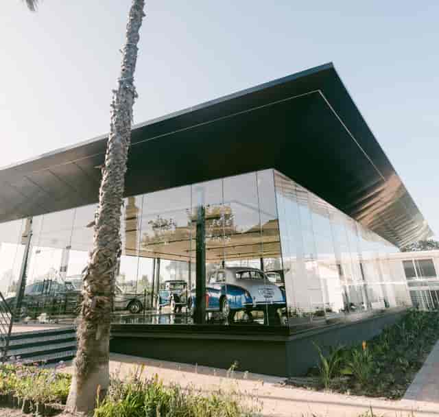Modern Glasshouse venue at Hazendal Wine Estate, ideal for events, with classic cars.