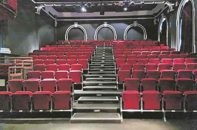 The Wave Theatre exhibition area with tiered red seating, ideal for performances and presentations.