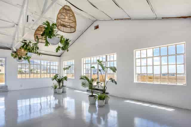 Bright rooftop terrace with large windows, ideal for corporate meetings and social gatherings.