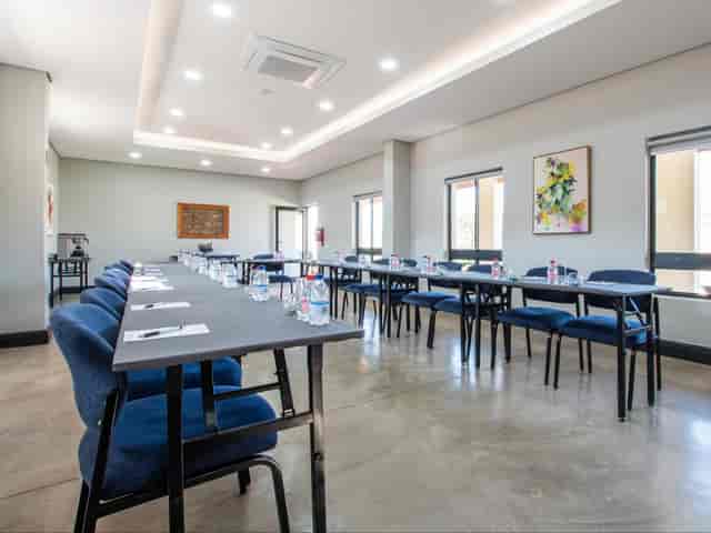 Boardroom at Eikenhof Estate with blue chairs, perfect for workshops and meetings.