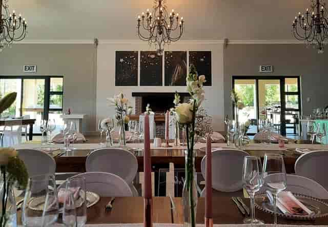 Elegant boardroom at Eikenhof Estate with floral accents, ideal for weddings and upscale events.