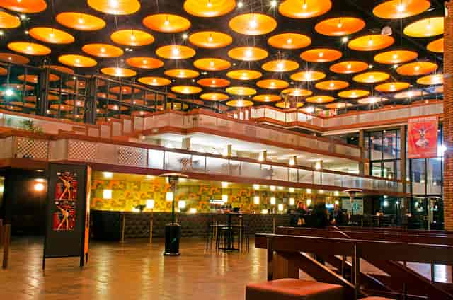 Modern Baxter Theatre space with warm ceiling lighting, perfect for corporate and social events.