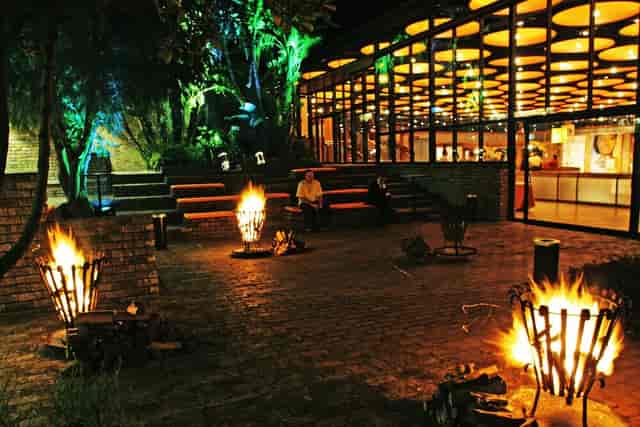 Inviting Baxter Theatre foyer with fire pits, perfect for outdoor evening events.