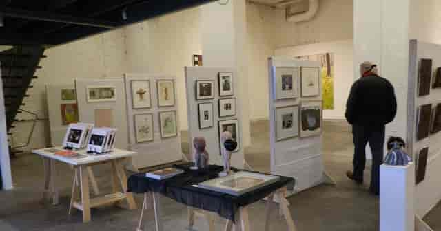 Art gallery exhibition with framed artworks and inviting layout for networking events.