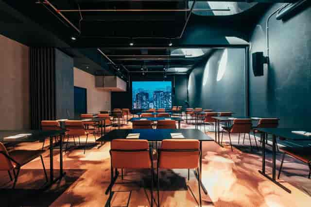 Modern conference room with large screen, ideal for meetings and events at Malmitalo.