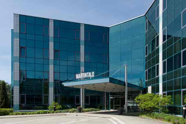 Modern corporate auditorium with glass facade, perfect for conferences and events.