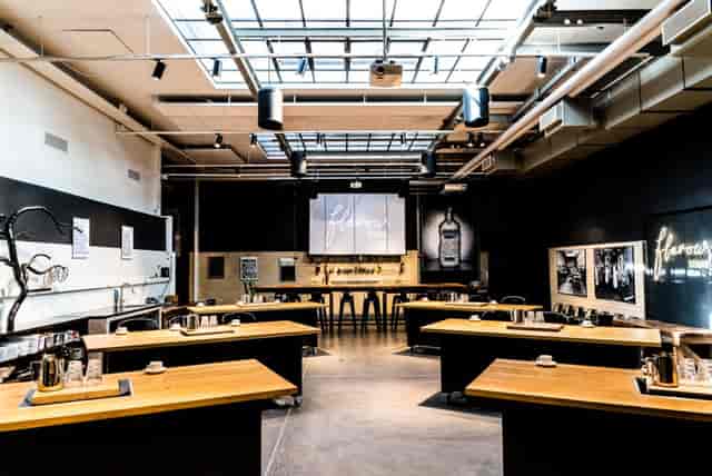 Modern event space with modular tables and skylight for workshops and meetings.