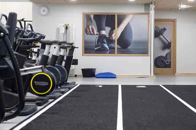 Modern fitness meeting room with exercise machines for wellness events and team-building activities.