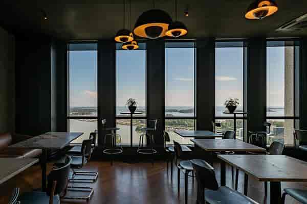 Modern event space in Dipoli with large windows for meetings and gatherings.