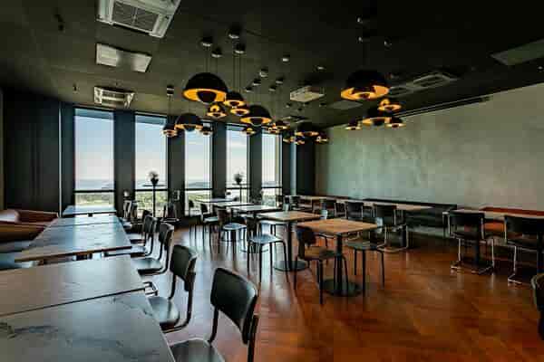 Modern event space in Dipoli with stylish lighting and versatile seating for meetings.