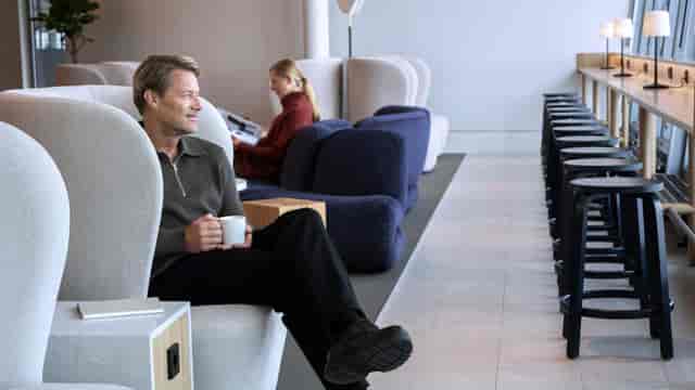 Modern lounge area with sculptural seating for networking and informal meetings in Munkkiniemi.