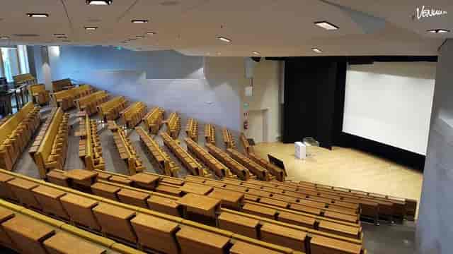 Aalto University lecture hall with tiered seating, ideal for conferences and presentations.