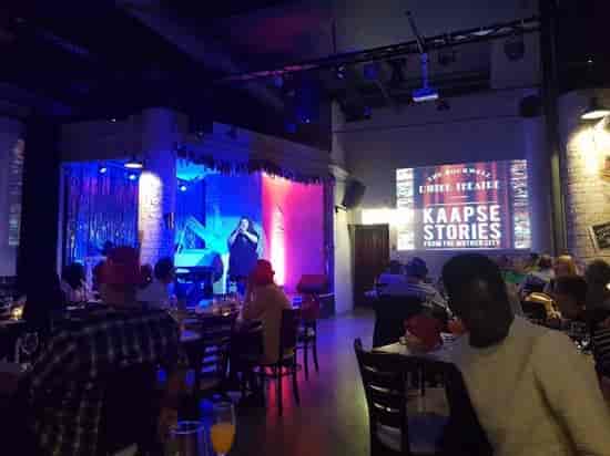Function room at The Rockwell Dinner Theatre, vibrant setup for Kaapse Stories event.