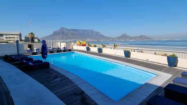 Poolside venue at Lagoon Beach Hotel with Table Mountain view for outdoor events.