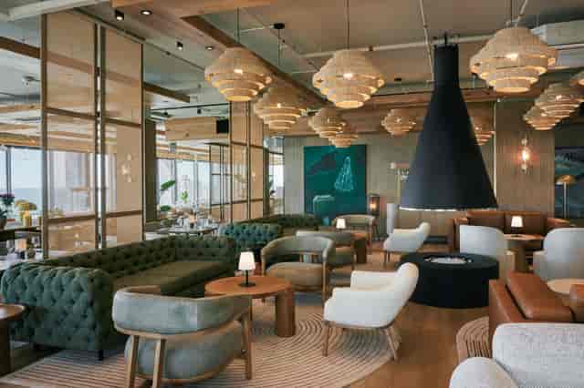 Stylish Rooftop Restaurant with cozy seating for networking events and informal meetings.