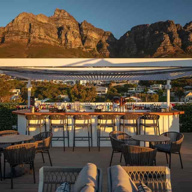 Rooftop Restaurant bar with modern seating and mountain views, perfect for events.