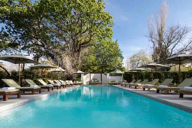 Serene poolside garden at The Alphen Hotel, ideal for corporate retreats and wellness events.