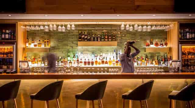 Stylish bar with illuminated shelves, perfect for cocktail receptions and networking events.