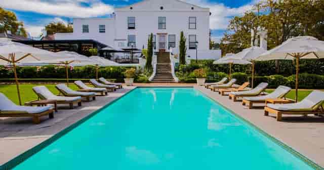 Elegant outdoor conference room at The Alphen Hotel with pool, ideal for upscale events.