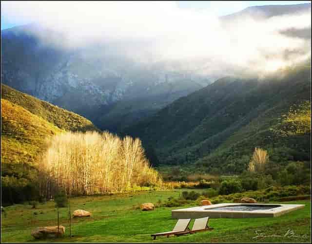 Glamping tents with a hot tub in Pat Busch Mountain Reserve for serene retreats.