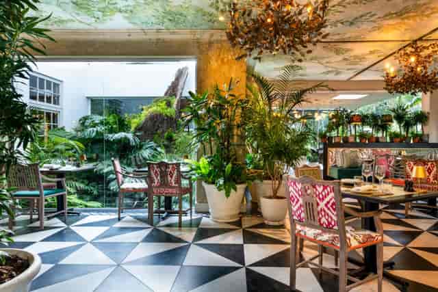 Greenhouse Restaurant event space with lush greenery, ideal for gatherings and receptions.