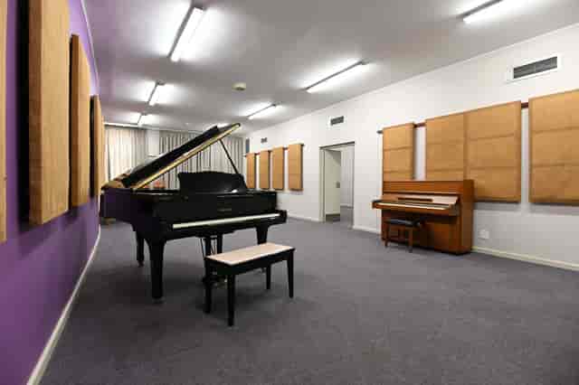 Cape Town Philharmonic rehearsal room with grand piano for music education events.