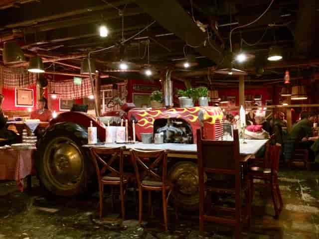 Red tractor centerpiece at Restaurant Zetor, ideal for themed events and networking.