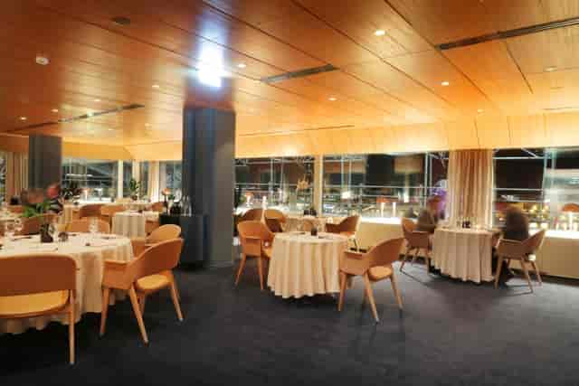Elegant ballroom with warm wood finishes, ideal for corporate dinners and networking events.