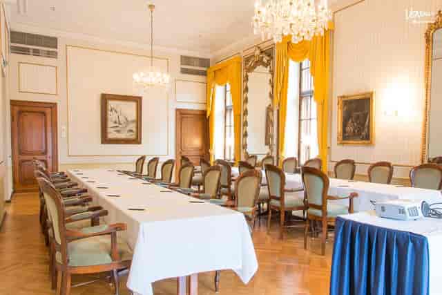 Elegant meeting room with long table, perfect for presentations and intimate events.