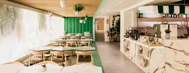 Kaivopiha Lounge, modern dining space with marble tables for events in Helsinki.