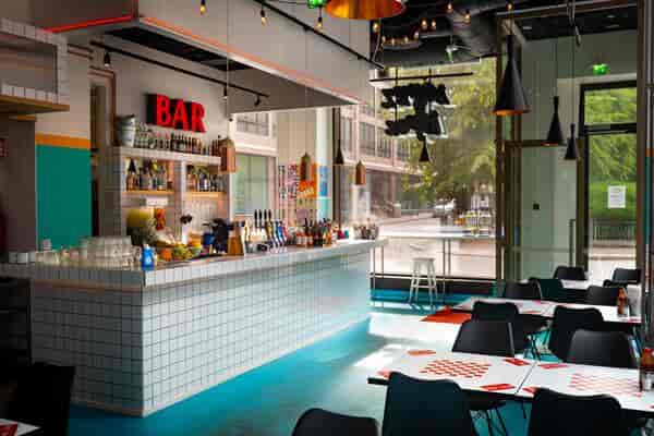 Modern bar in Kaiku with colorful decor for social events and networking.