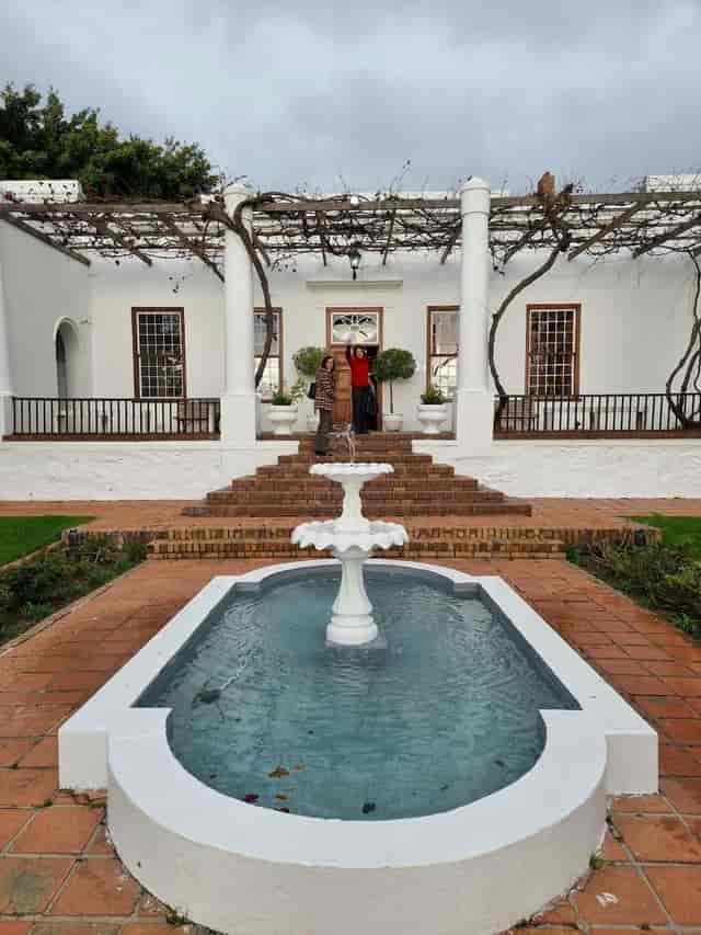 Elegant Manor House venue with fountain, perfect for weddings and corporate events.