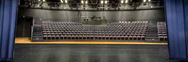 Spacious auditorium in Annantalo with tiered seating for events and performances.