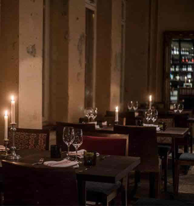 Elegant bistro dining with candlelight ambiance for intimate events and upscale gatherings.